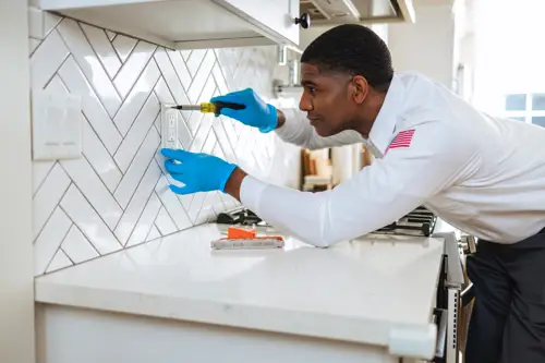 Tech working on kitchen outlet