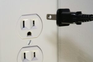 plug being inserted into loose electrical outlet