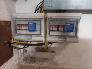 whole-house surge protectors installed underneath homeowners electrical panel